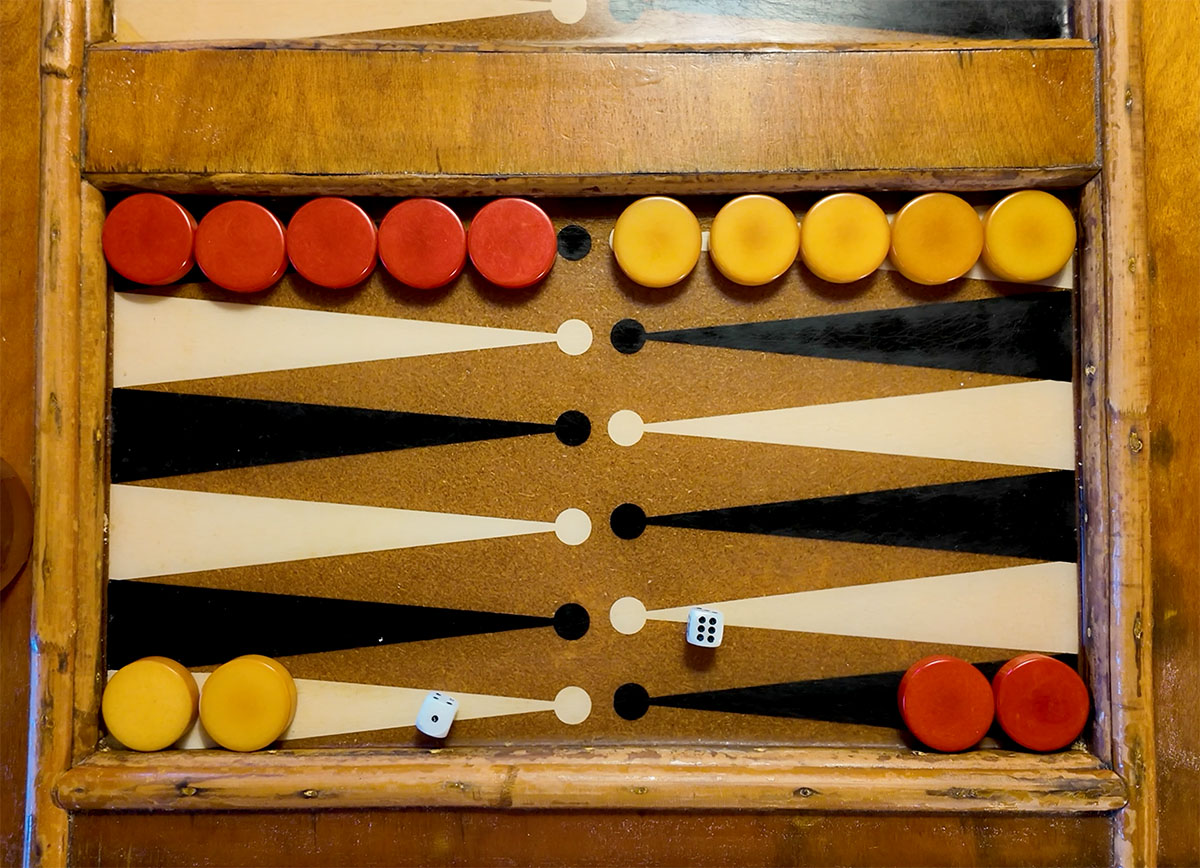 Wooded backgammon board with pieces and dice.