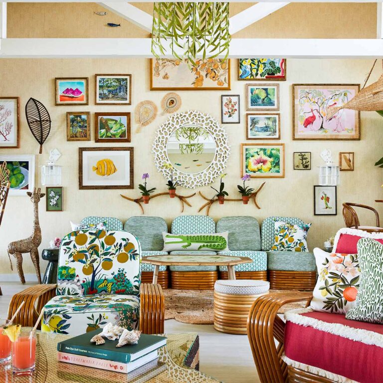 A Beach Club sitting area with boldly upholstered furniture and a large variety of ocean-themed framed paintings