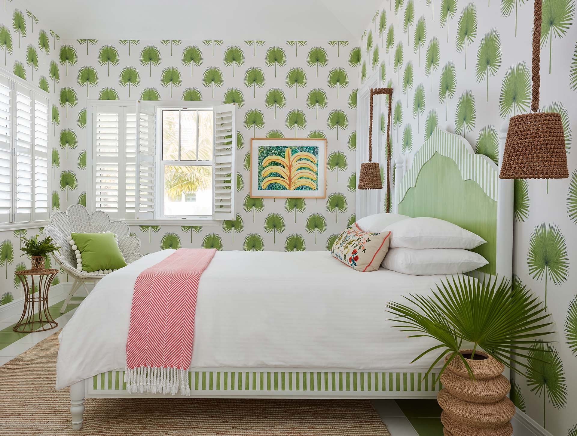 Comfy guest room with bold palmetto-themed wallpaper
