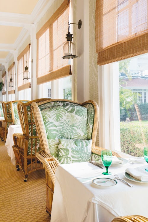 A cushioned, high-backed chair of a dining area two-top