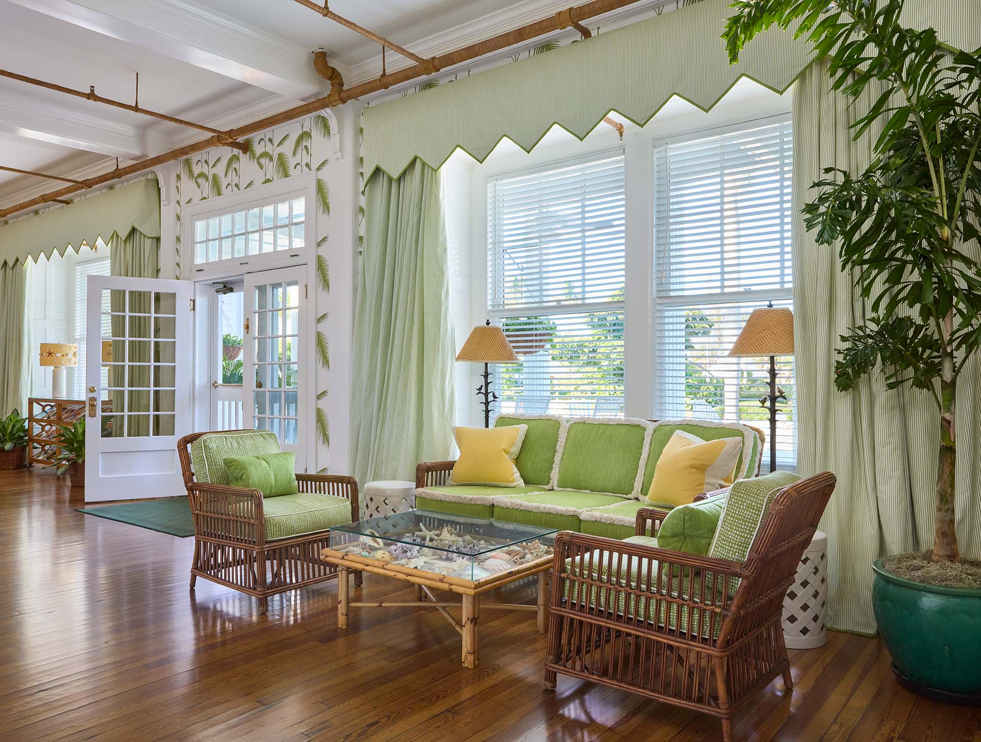 A green-themed seating area of wicker furniture in the Inn's "living room"