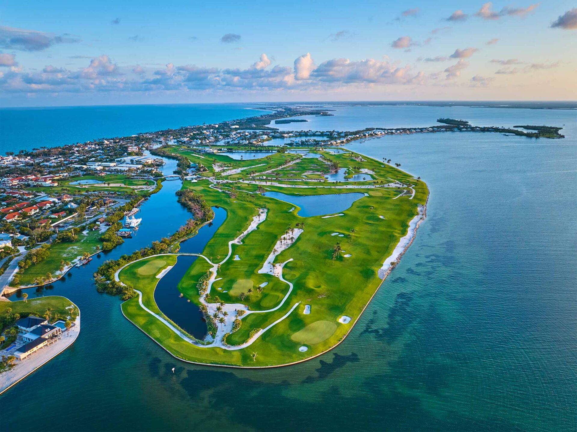 Island with golf course and waterways from the sky.